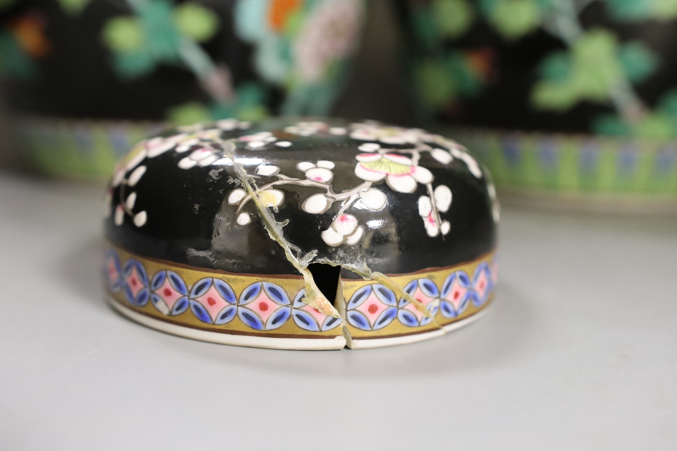A pair of Japanese famille noire jars and covers 27cm